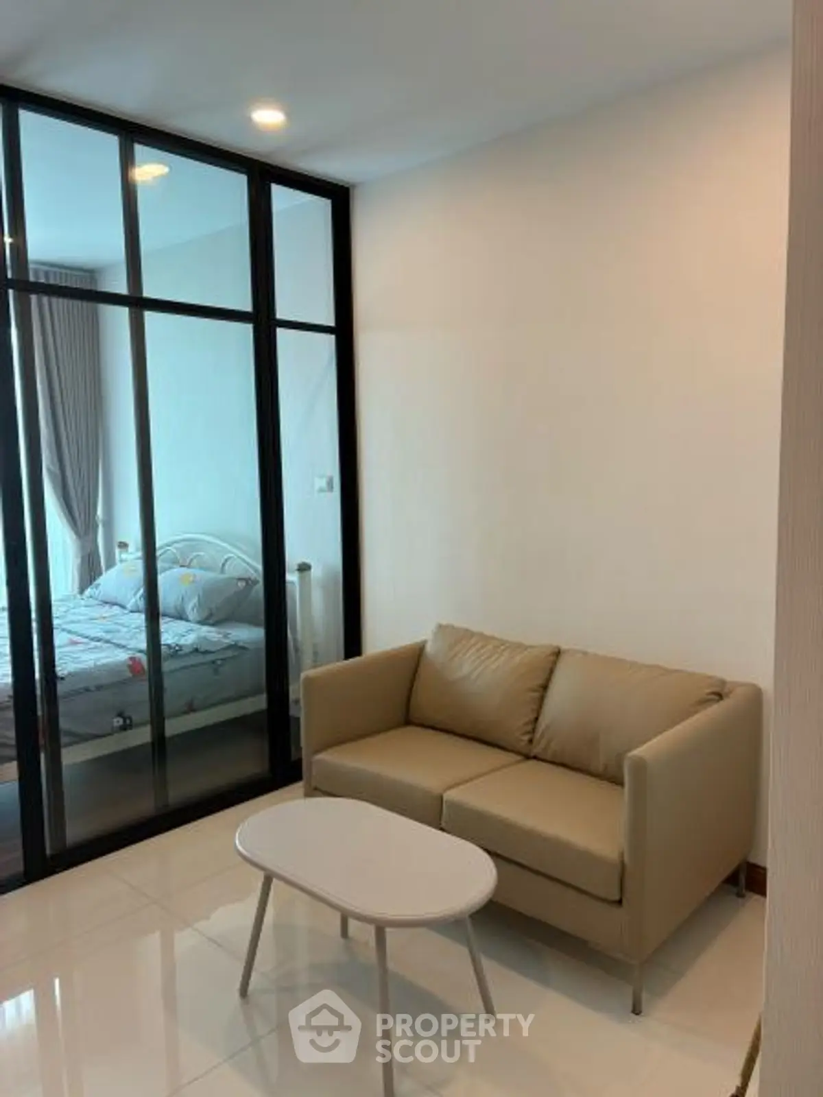 Modern apartment with cozy living room and glass partitioned bedroom