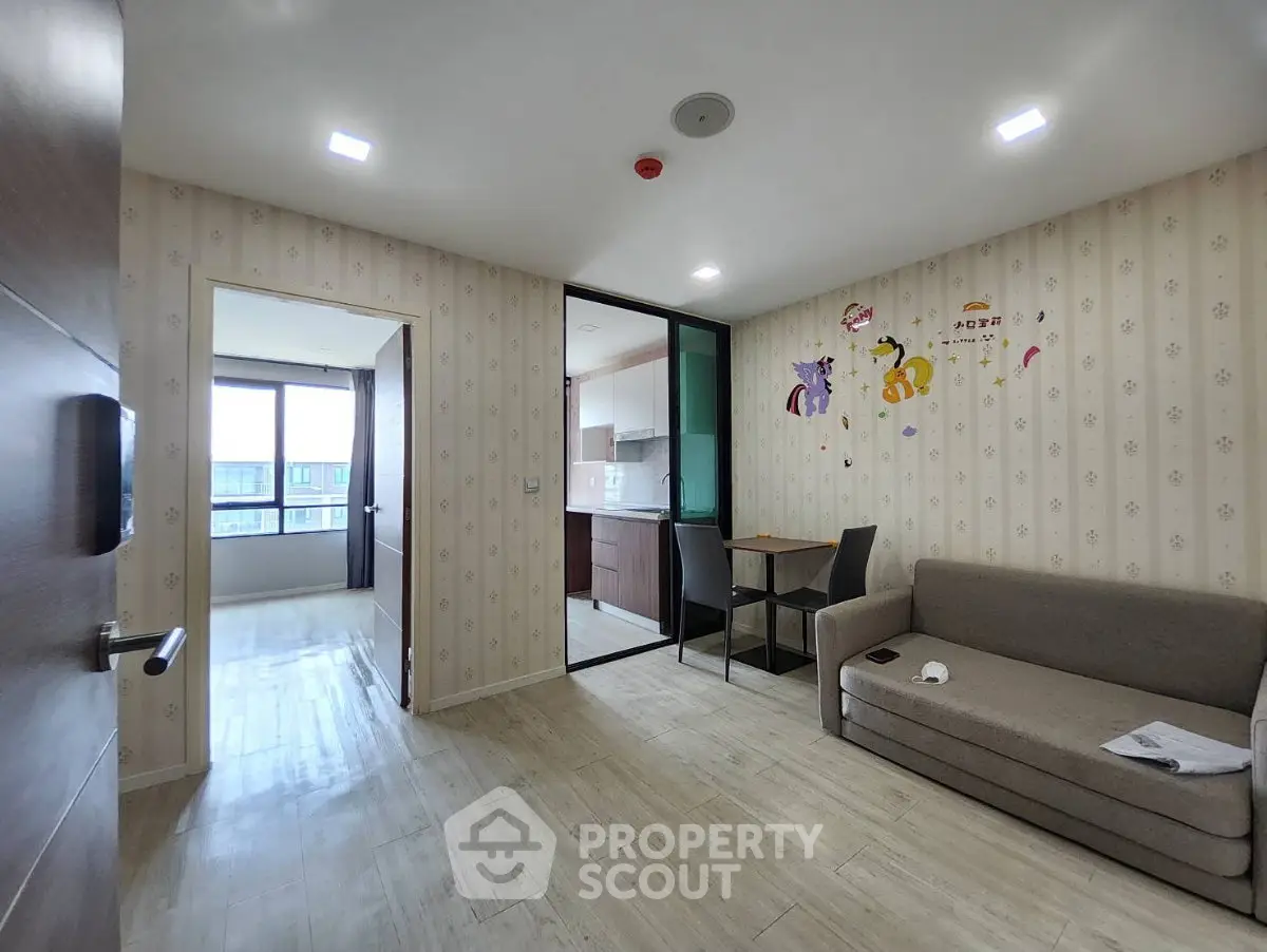 Modern apartment interior with cozy living room and kitchen, featuring stylish decor and ample natural light.