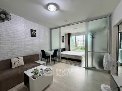 Modern studio apartment with open layout and stylish decor, featuring a cozy living area and bedroom with natural light.