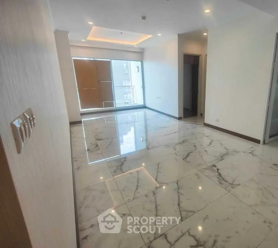 Spacious modern living room with marble flooring and large windows