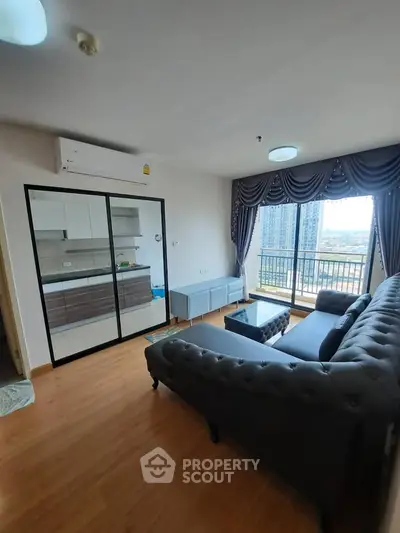 Modern living room with elegant sofa and balcony view in high-rise apartment