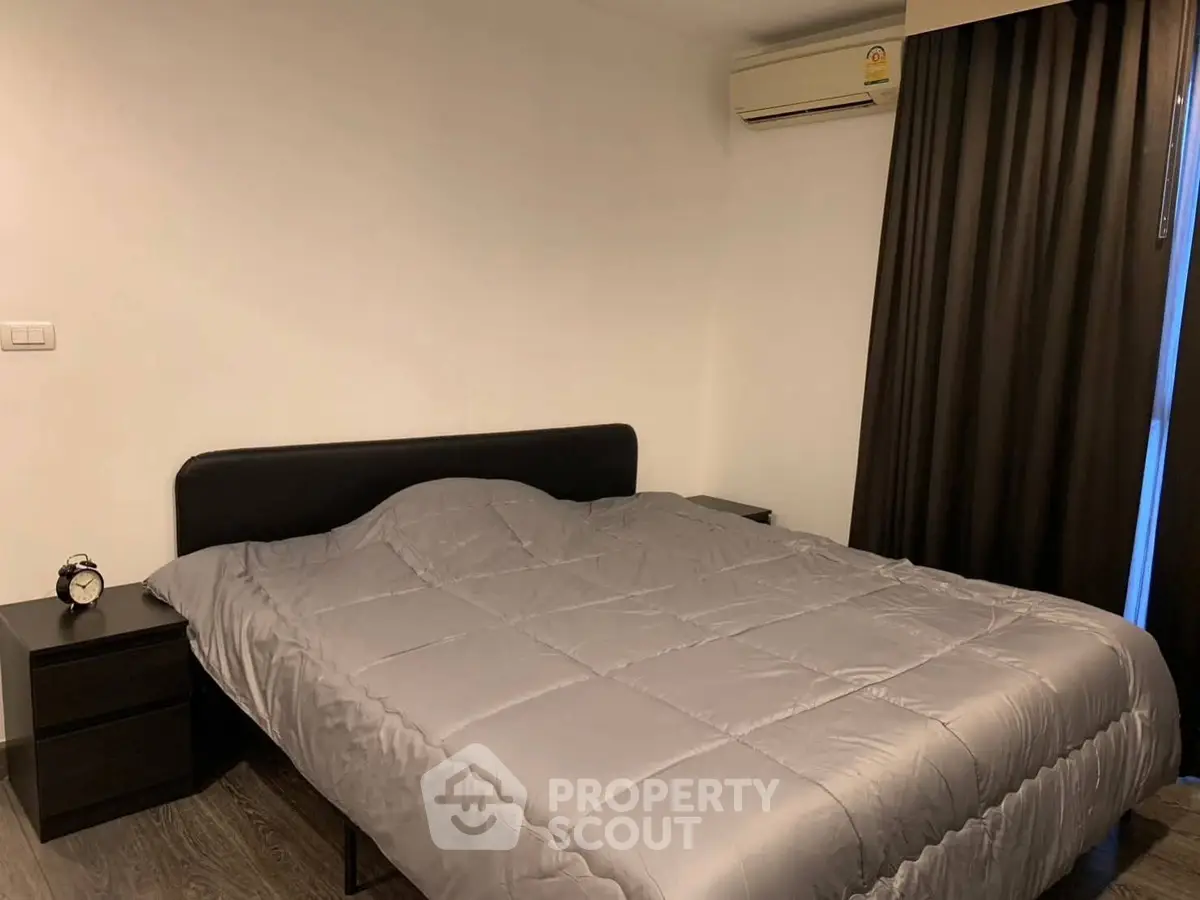 Cozy bedroom with modern decor and air conditioning, perfect for restful nights.