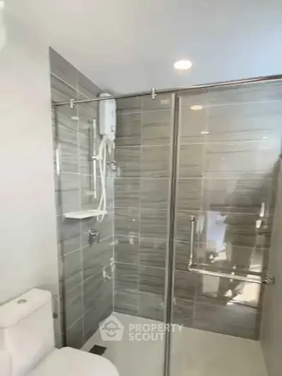 Modern bathroom with glass shower enclosure and sleek tile design