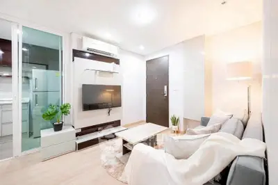 Modern living room with sleek design, cozy sofa, and stylish decor in a bright apartment.
