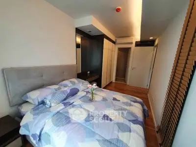 Modern bedroom with stylish decor and ample storage in a cozy apartment