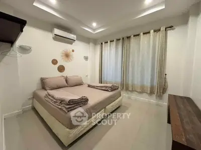 Cozy bedroom with modern decor and ample natural light