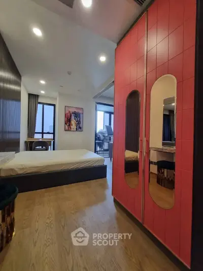 Modern bedroom with stylish red wardrobe and city view