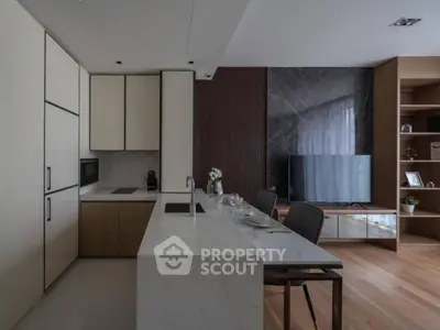 Modern open-plan kitchen and living room with sleek design and elegant finishes.