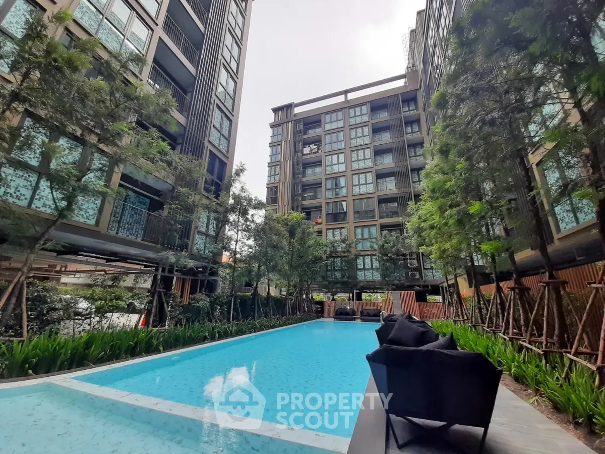 Luxurious condominium with stunning pool and lush greenery, perfect for modern urban living.