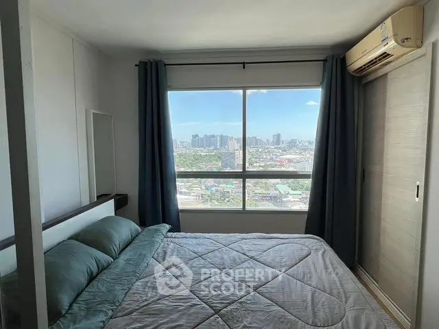 Modern bedroom with city view and air conditioning in high-rise apartment.