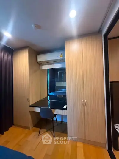 Modern bedroom with built-in wardrobe and sleek study area