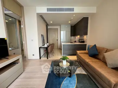Modern living room with stylish furniture and open kitchen layout in a contemporary apartment.