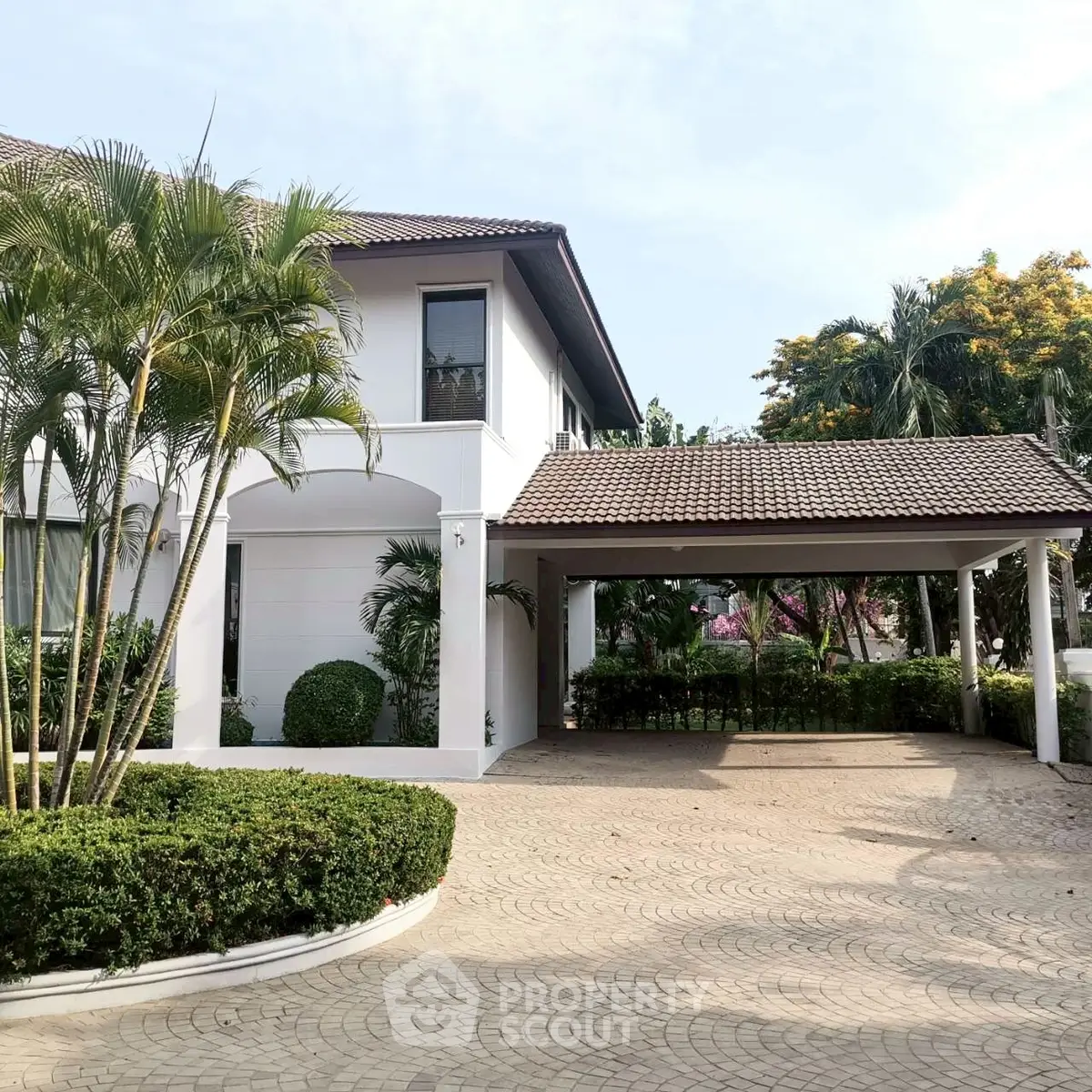 Elegant suburban home with spacious driveway and lush greenery