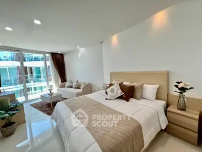 Spacious modern bedroom with elegant decor and large windows offering natural light.