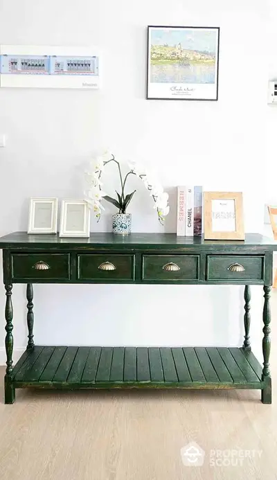 Elegant green console table with decorative accents in stylish interior setting