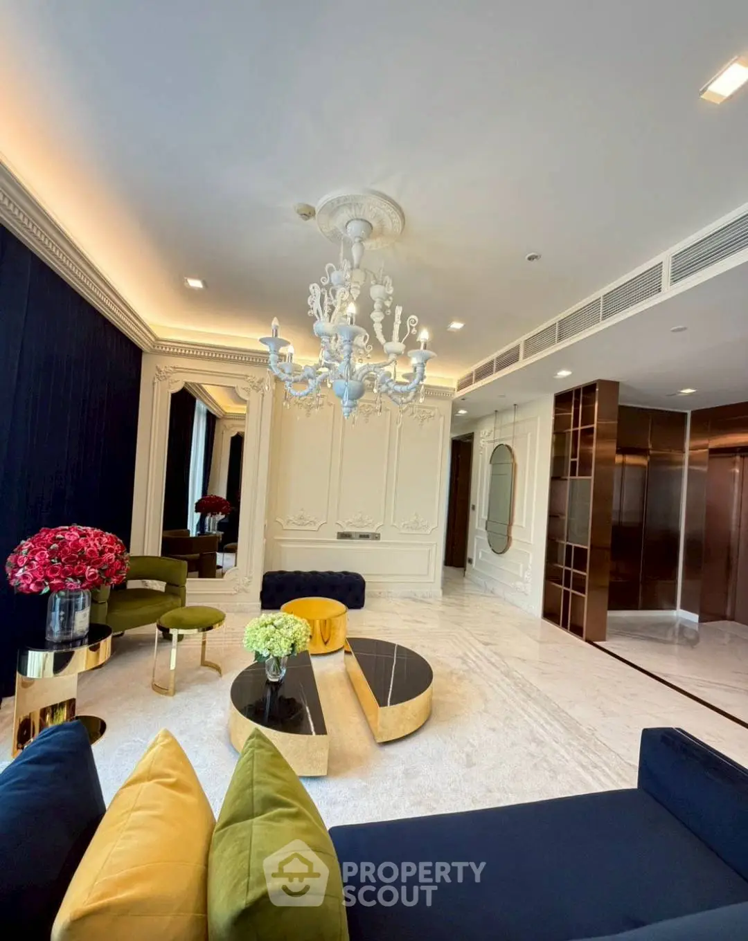 Luxurious living room with elegant chandelier and modern decor in upscale apartment.