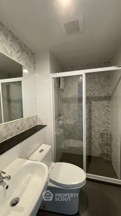 Modern bathroom with glass shower and stylish tile design
