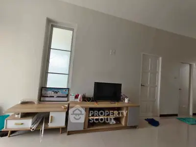 Spacious living room with modern TV stand and natural light