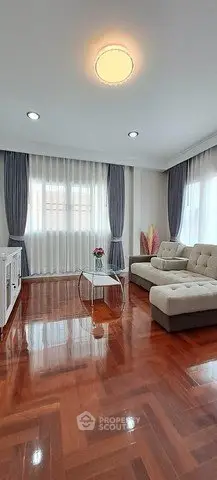 Spacious living room with elegant hardwood floors and modern furniture