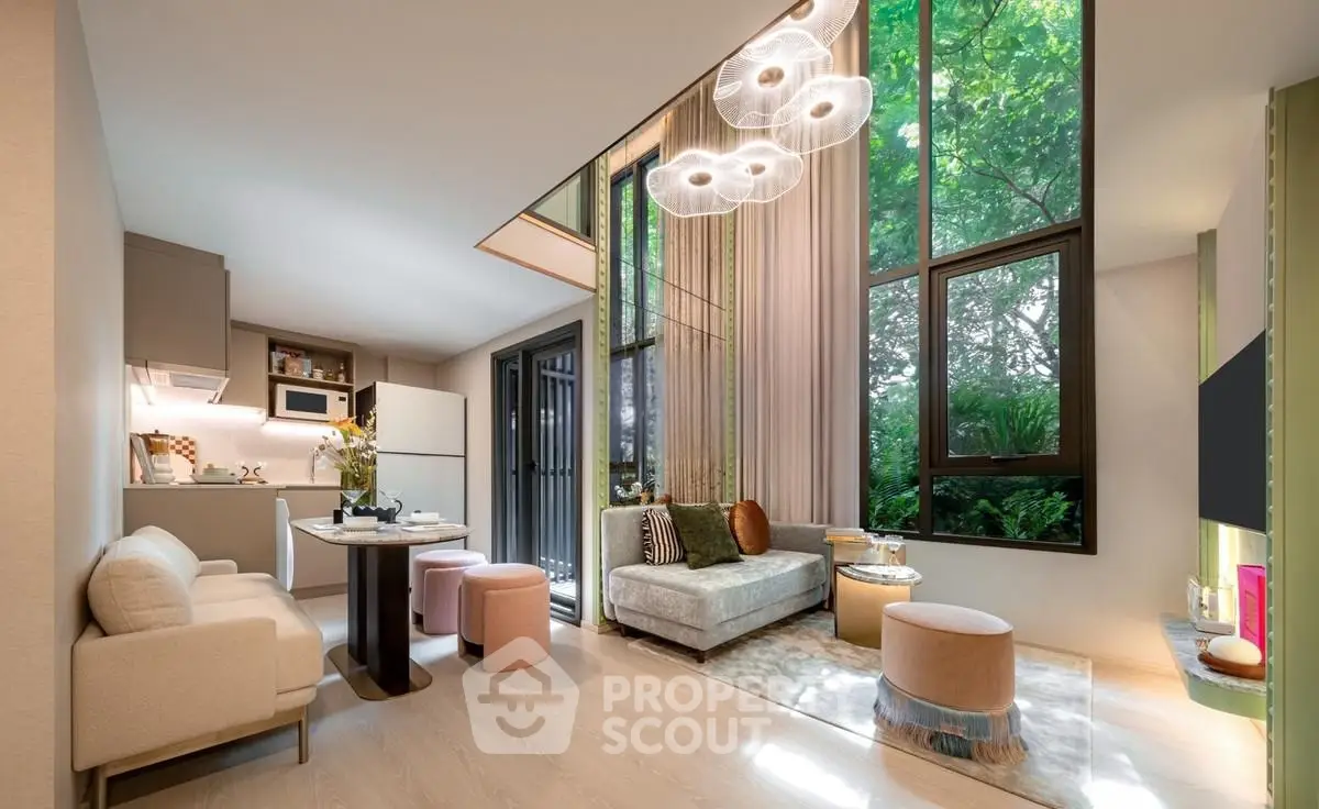 Luxurious modern living room with high ceilings and large windows overlooking greenery, featuring elegant decor and open kitchen.