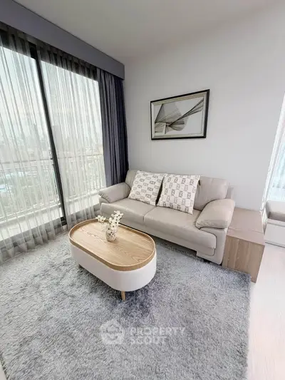 Modern living room with cozy sofa, stylish coffee table, and large window with city view.