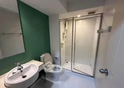 Modern bathroom with sleek shower enclosure and stylish sink in contemporary apartment.