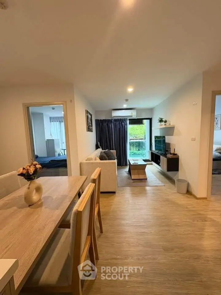 Spacious modern living room with dining area and balcony view