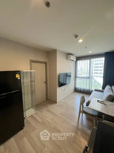 Modern living room with sleek furniture and large window view