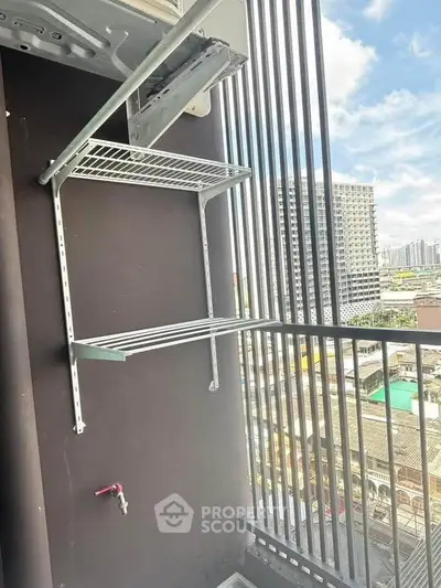 Modern balcony with city view and metal shelving, perfect for urban living.