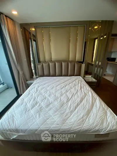 Luxurious bedroom with elegant decor and large windows offering natural light.