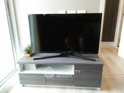 Modern living room with sleek TV stand and flat-screen TV