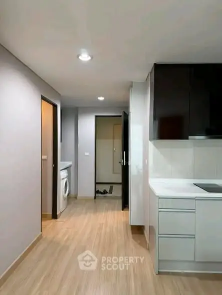 Modern kitchen with sleek cabinetry and integrated appliances in a stylish apartment.