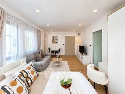 Spacious modern living room with cozy seating and stylish decor in a bright apartment.