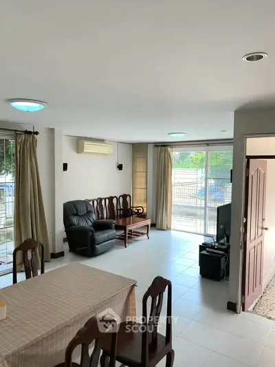 Spacious living room with modern furniture and large windows for natural light.