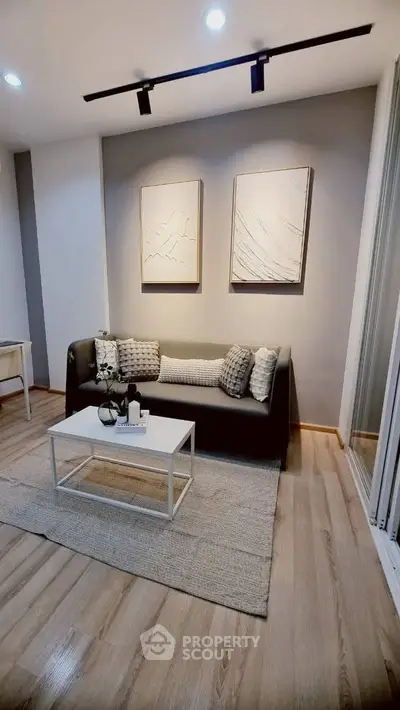 Modern living room with stylish decor and cozy seating area, perfect for relaxation and entertaining.