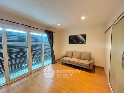 Spacious living room with modern sofa and large windows for natural light