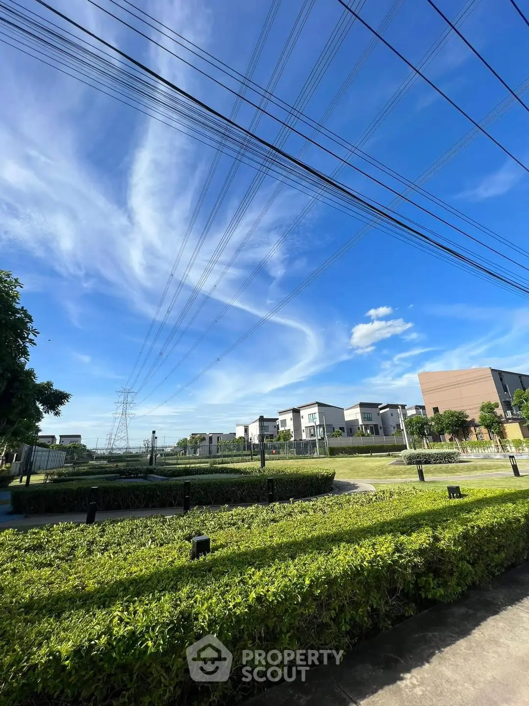 Stunning residential area with lush greenery and modern homes under a clear blue sky.