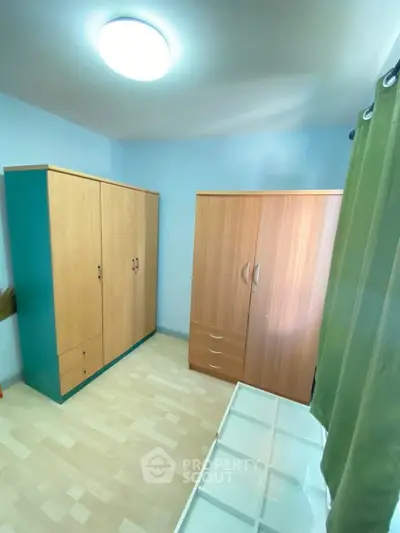 Spacious bedroom with ample wardrobe storage and natural light.