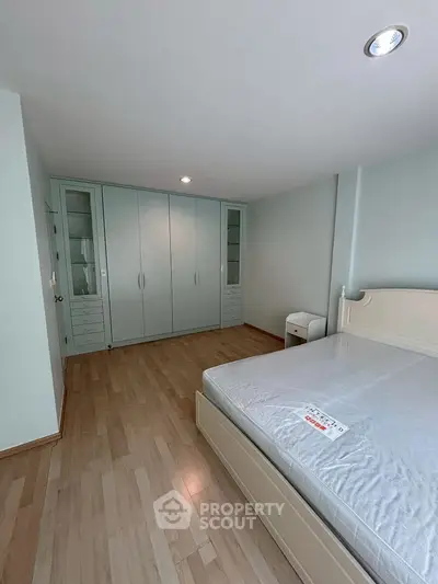 Spacious bedroom with modern wardrobe and elegant flooring