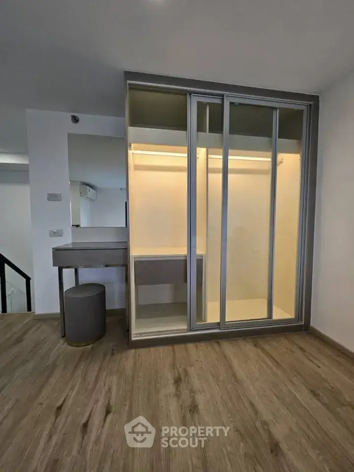 Modern interior with stylish walk-in closet and elegant flooring