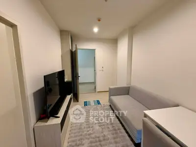 Modern living room with sleek furniture and neutral tones, perfect for relaxation and entertainment.