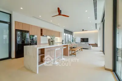 Spacious open-plan kitchen and living area with modern design and natural light.