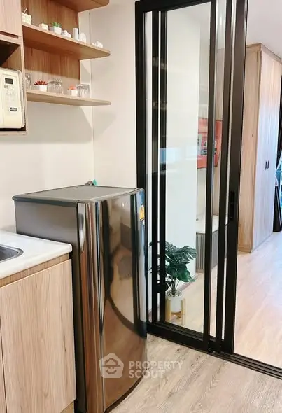 Modern kitchen with sleek appliances and sliding glass door