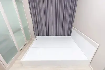 Minimalist bedroom with modern bed frame and sliding closet doors