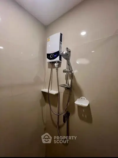 Modern bathroom with sleek shower unit and water heater, perfect for a comfortable living experience.