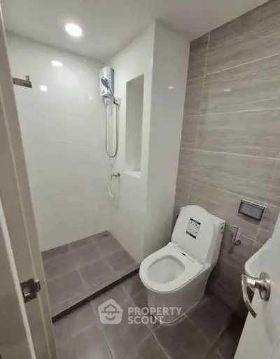 Modern bathroom with sleek design and walk-in shower in a contemporary apartment.