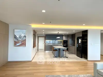 Modern open-layout kitchen with sleek appliances and stylish bar seating