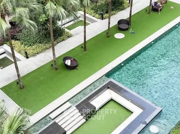 Luxurious outdoor pool area with lush greenery and modern design, perfect for relaxation and leisure.
