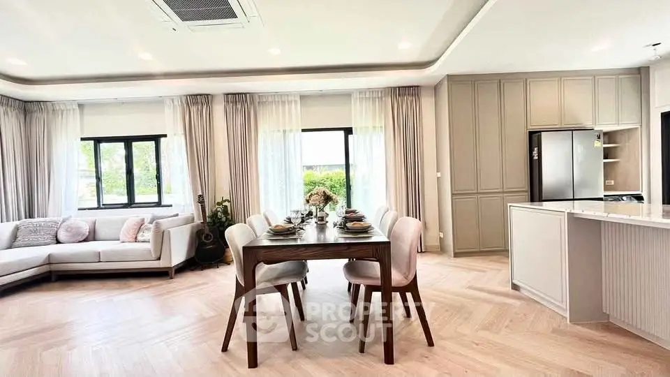 Spacious open-plan living and dining area with modern decor and natural light.
