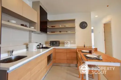 Modern kitchen with wooden cabinets and open shelving in a cozy apartment